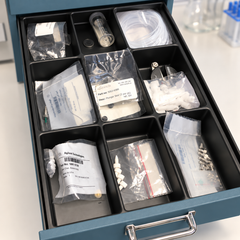 RECOLSERT nine-compartment tray in a standard muted teal drawer; cabinet and contents not included